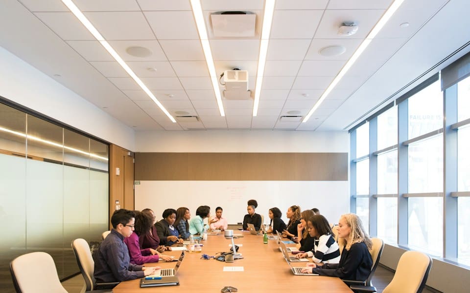 A team in a meeting around a table in a bright room